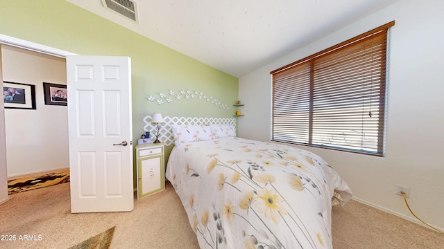 bedroom with vaulted ceiling and light carpet