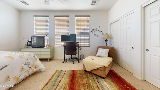 bedroom with light carpet and a closet