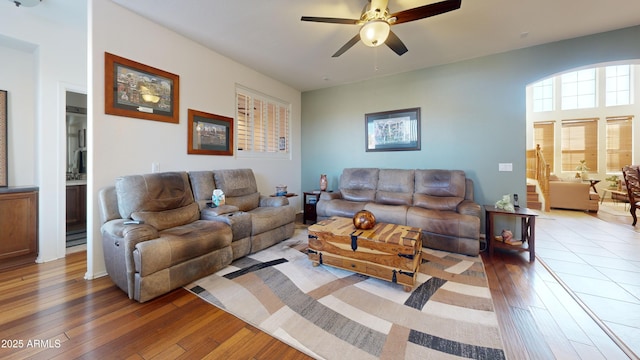 living room with light hardwood / wood-style floors and ceiling fan