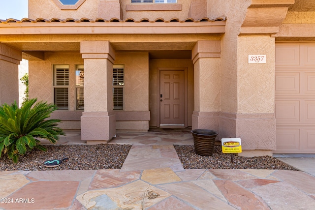 property entrance featuring a garage and covered porch