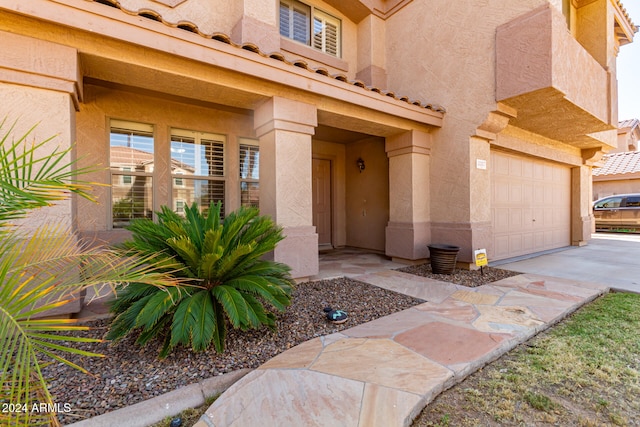 view of exterior entry with a garage