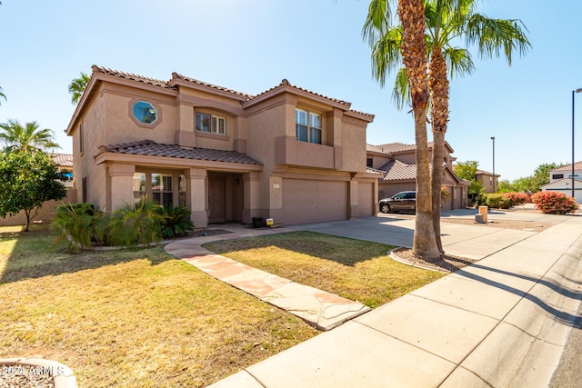 mediterranean / spanish house with a front yard and a garage