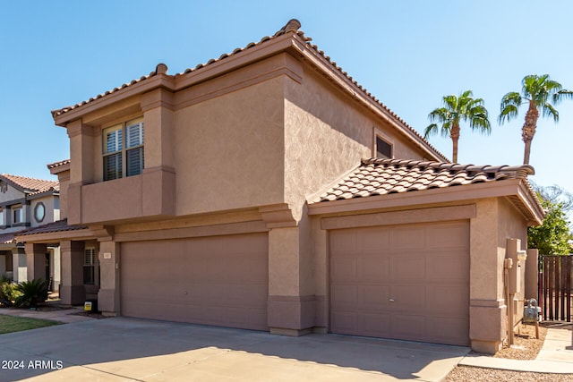 mediterranean / spanish-style home with a garage