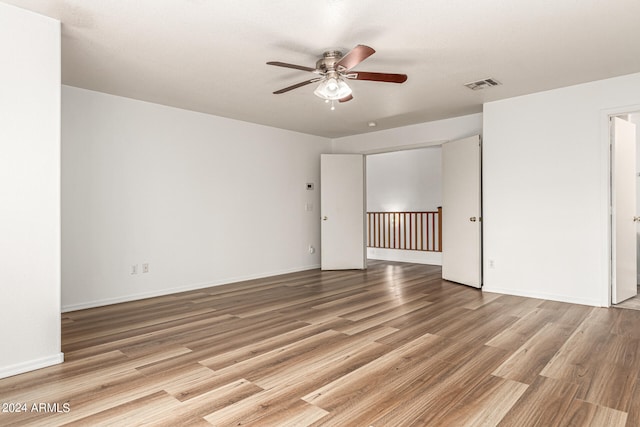 spare room featuring light hardwood / wood-style flooring and ceiling fan