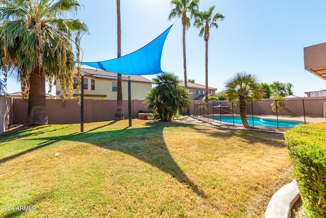 view of yard with a fenced in pool