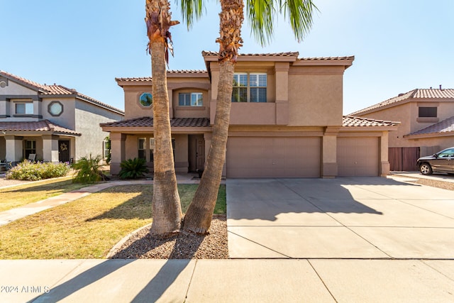 mediterranean / spanish-style home with a garage