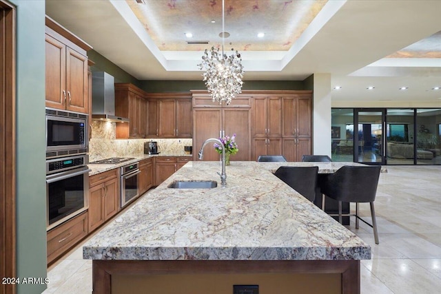 39254 N 104th Pl, Scottsdale, AZ 85262 - kitchen with tasteful backsplash, wall chimney exhaust hood, a sink, a tray ceiling, and stainless steel appliances