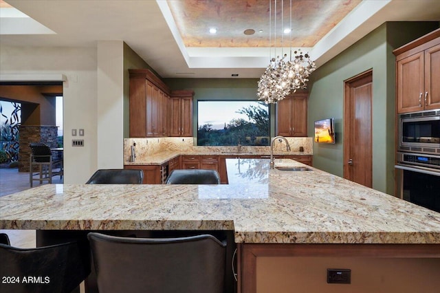 39254 N 104th Pl, Scottsdale, AZ 85262 - kitchen featuring a sink, decorative backsplash, a raised ceiling, and stainless steel appliances