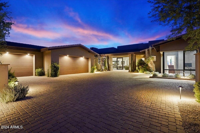 39254 N 104th Pl, Scottsdale, AZ 85262 - view of front of property with an attached garage, decorative driveway, and stucco siding