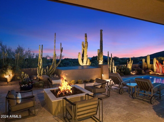 39254 N 104th Pl, Scottsdale, AZ 85262 - patio terrace at dusk featuring an outdoor fire pit and a fenced in pool