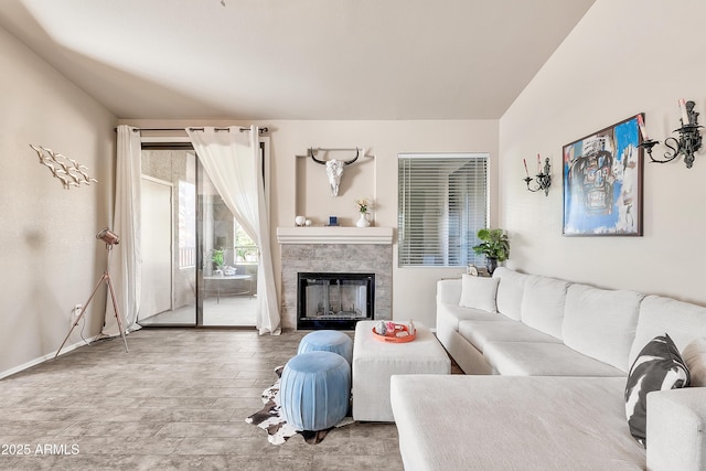 living room with wood finished floors and a glass covered fireplace