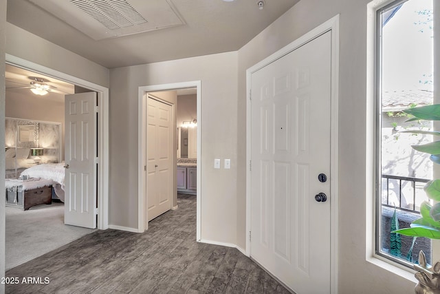 entryway featuring dark wood-style floors, visible vents, and baseboards