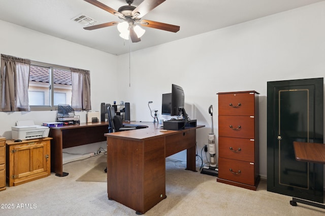 office featuring visible vents, ceiling fan, and light carpet