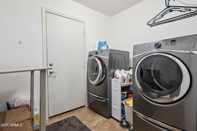 clothes washing area featuring washer and clothes dryer and laundry area