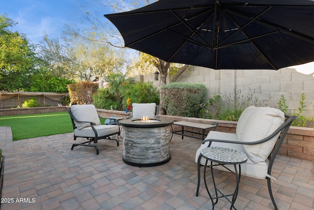view of patio with a fenced backyard and a fire pit