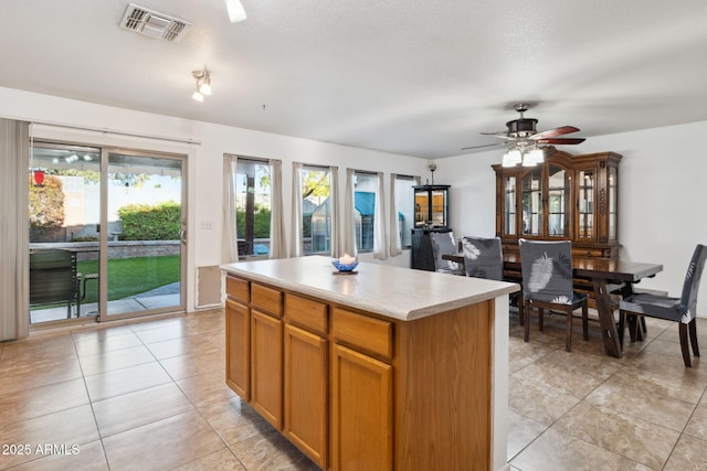 kitchen featuring visible vents, light tile patterned flooring, and a healthy amount of sunlight