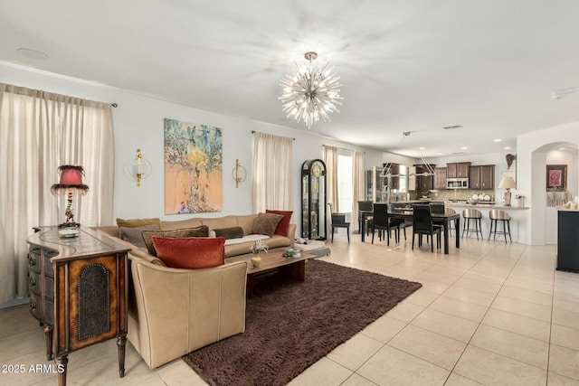 living room with arched walkways, recessed lighting, a notable chandelier, and light tile patterned floors