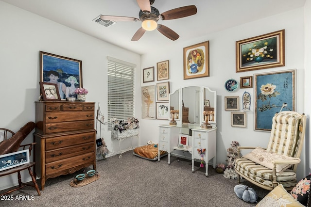 interior space featuring ceiling fan, visible vents, and carpet