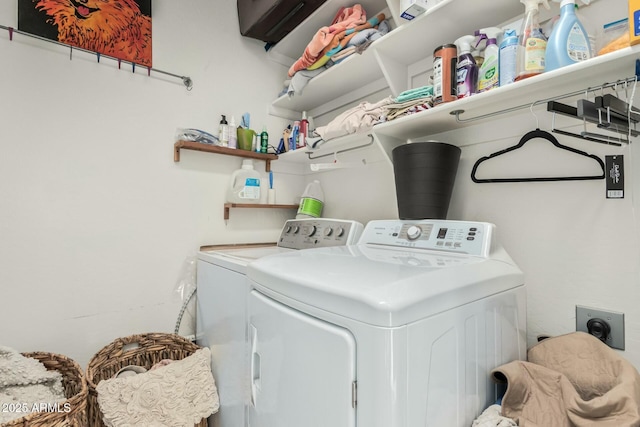 clothes washing area with washing machine and dryer and laundry area