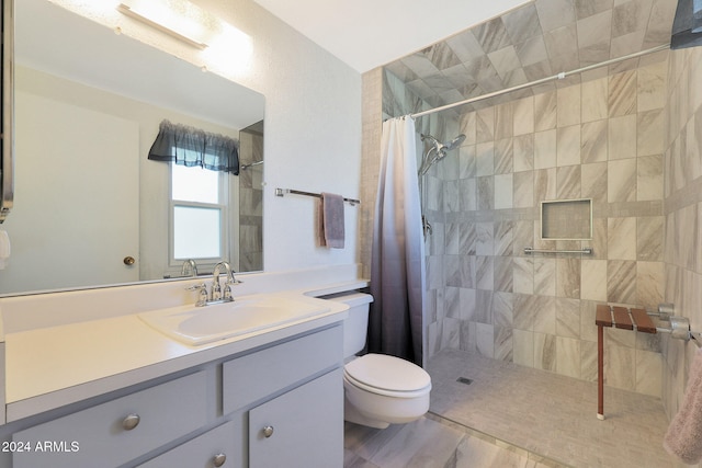 bathroom with toilet, vanity, and a shower with shower curtain