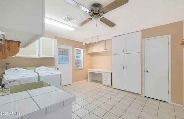 laundry room with cabinets, light tile patterned flooring, washing machine and dryer, and ceiling fan