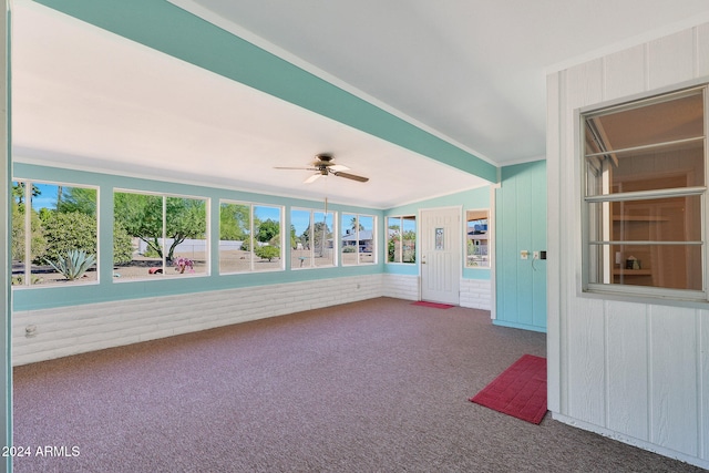 unfurnished sunroom featuring ceiling fan