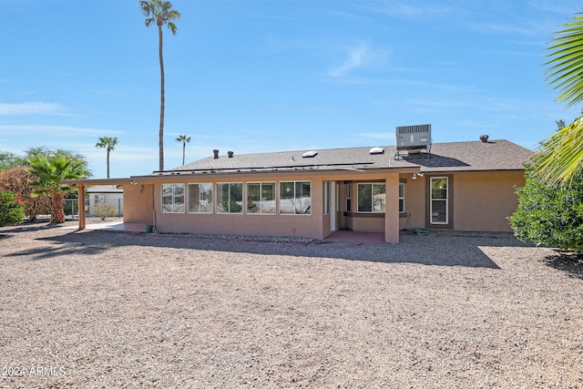 rear view of property featuring central air condition unit and a patio area