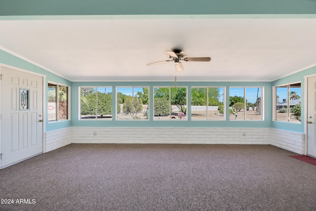 unfurnished sunroom featuring a healthy amount of sunlight and ceiling fan