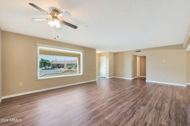 spare room with a textured ceiling, hardwood / wood-style flooring, and ceiling fan