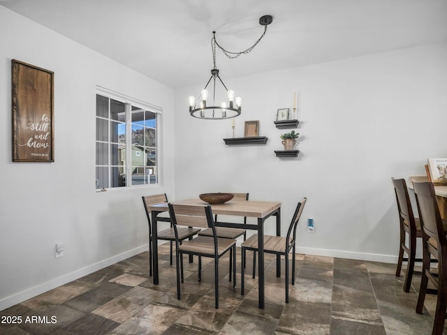 dining area featuring a notable chandelier