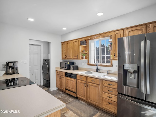 kitchen featuring appliances with stainless steel finishes, washer / clothes dryer, and sink