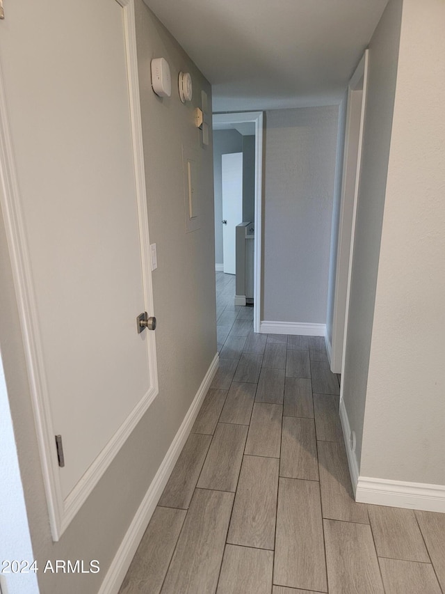 1942 S Emerson Unit 131, Mesa, AZ 85210 - hall featuring wood finish floors and baseboards