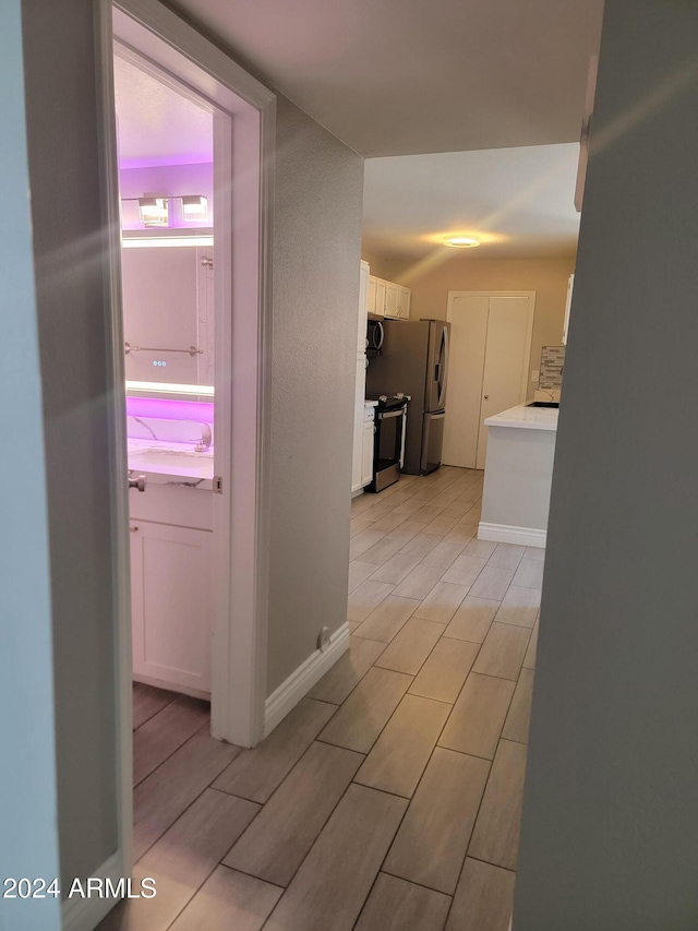 1942 S Emerson Unit 131, Mesa, AZ 85210 - hall featuring wood finish floors and baseboards