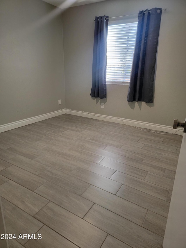 spare room featuring light wood-type flooring