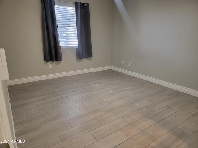 empty room with light hardwood / wood-style floors