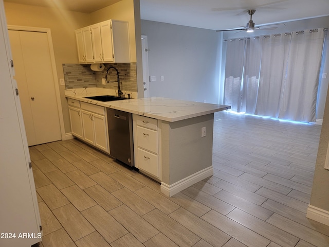 kitchen featuring white cabinets, light hardwood / wood-style floors, stainless steel dishwasher, and sink