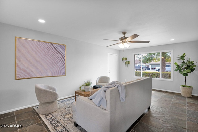 living room featuring recessed lighting, stone tile floors, baseboards, and ceiling fan