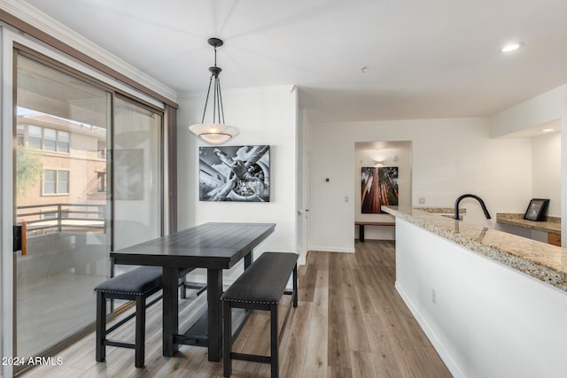 dining area featuring sink and light hardwood / wood-style floors