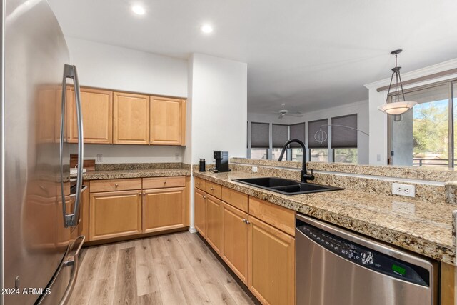 kitchen featuring stainless steel appliances, light brown cabinetry, sink, light hardwood / wood-style floors, and ceiling fan