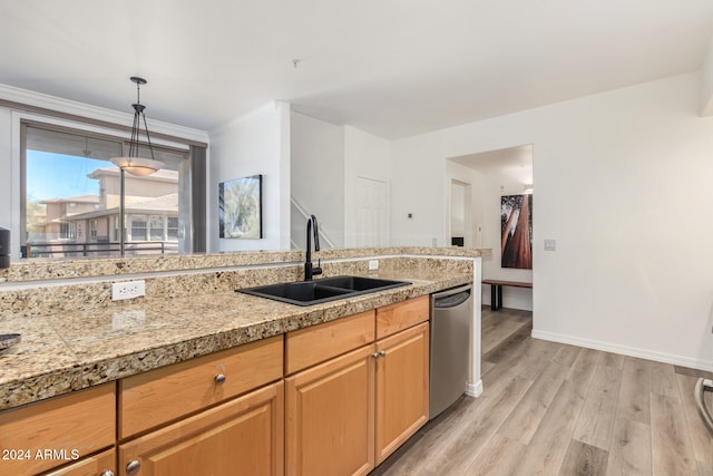 kitchen with crown molding, light wood-type flooring, hanging light fixtures, sink, and dishwasher