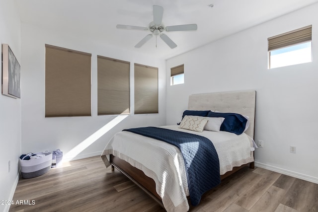 bedroom with wood-type flooring and ceiling fan