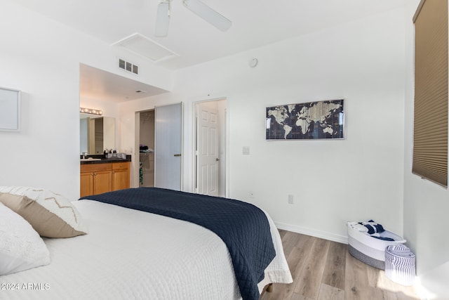 bedroom with ceiling fan, ensuite bath, and light hardwood / wood-style flooring