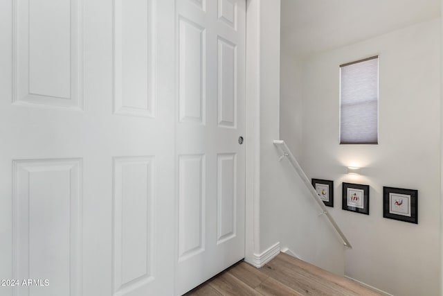 stairs with hardwood / wood-style flooring