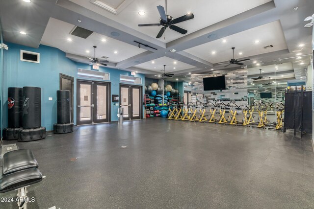 workout area featuring french doors and coffered ceiling