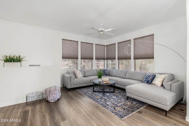 living room with wood-type flooring, ceiling fan, and crown molding