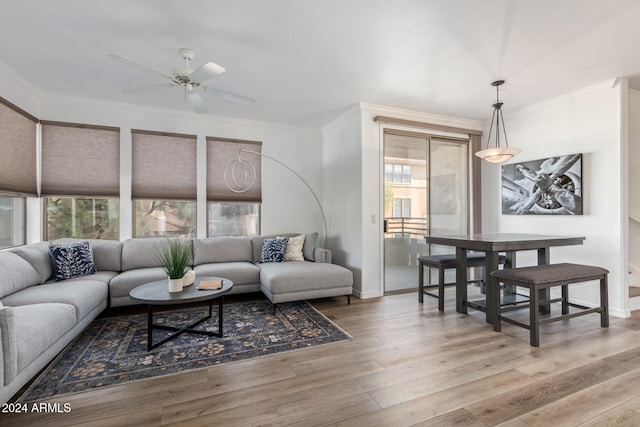 living room featuring ornamental molding, ceiling fan, and light hardwood / wood-style floors