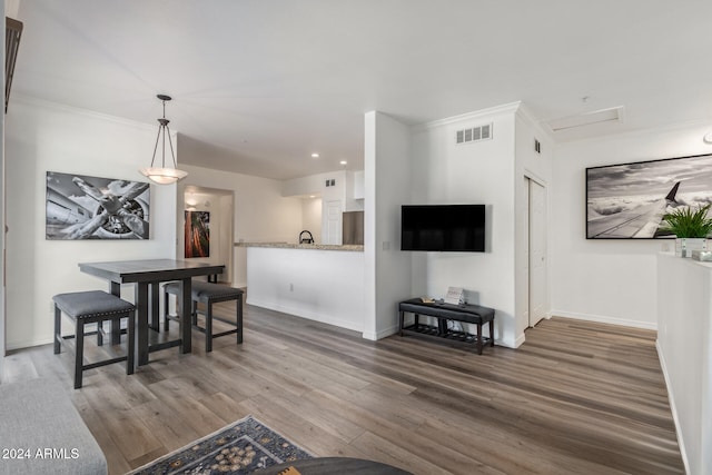 living room with dark hardwood / wood-style floors and crown molding