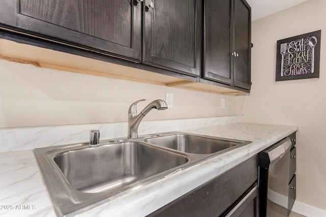 kitchen with stainless steel dishwasher, sink, and dark brown cabinets