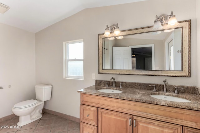 bathroom featuring tile patterned flooring, vanity, vaulted ceiling, and toilet