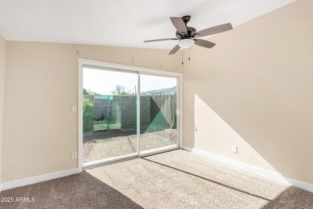 carpeted spare room with ceiling fan